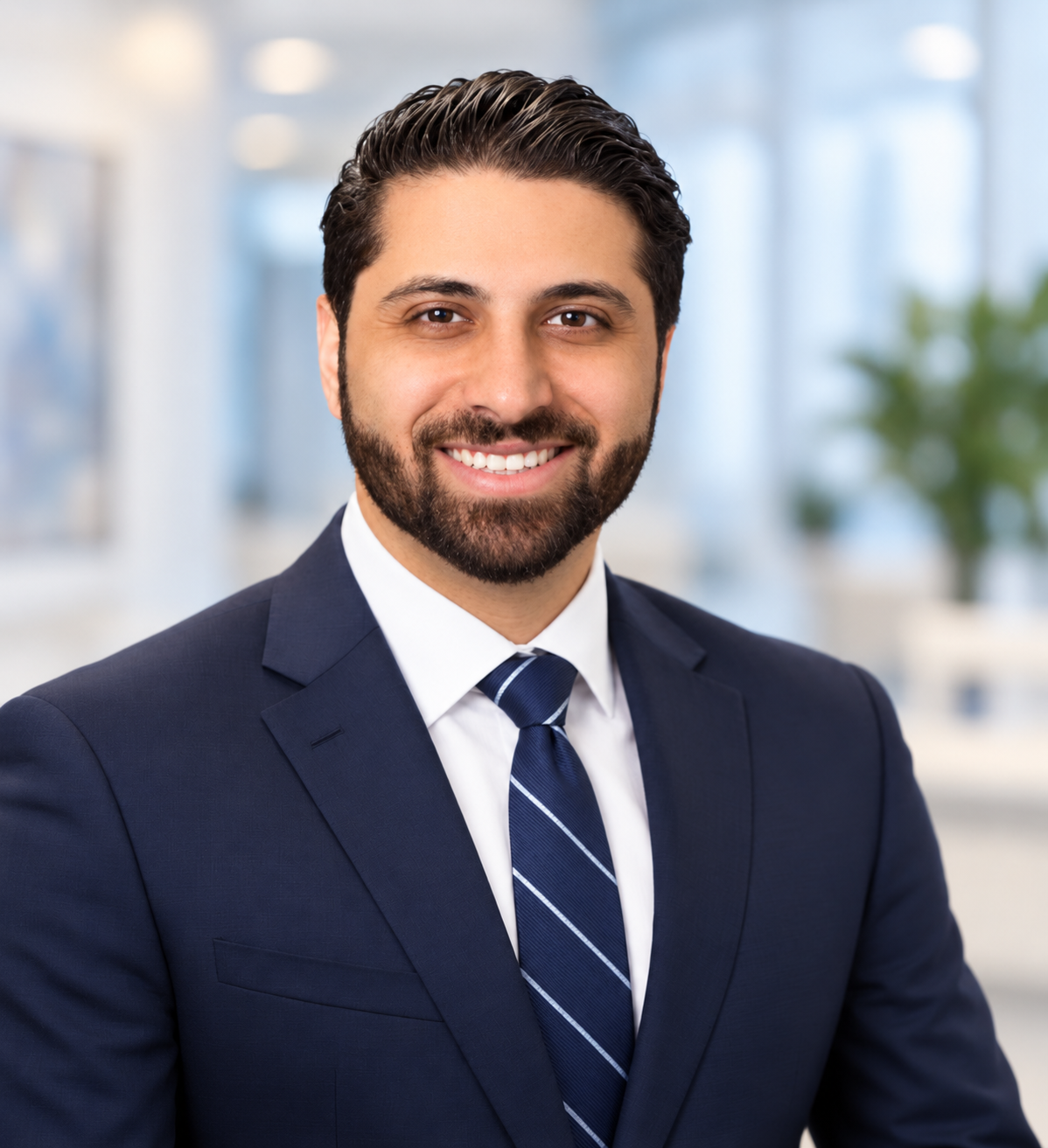 Professional portrait of Sam Harouni, DDS, MD in a navy suit